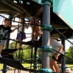 a group of kids climbing on a playground